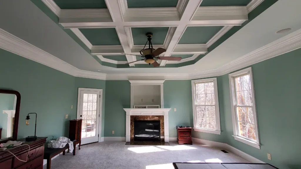 A green interior coffered ceiling in a master bedroom with custom painting details and design by A Touch of Color Painting in Raleigh, NC.