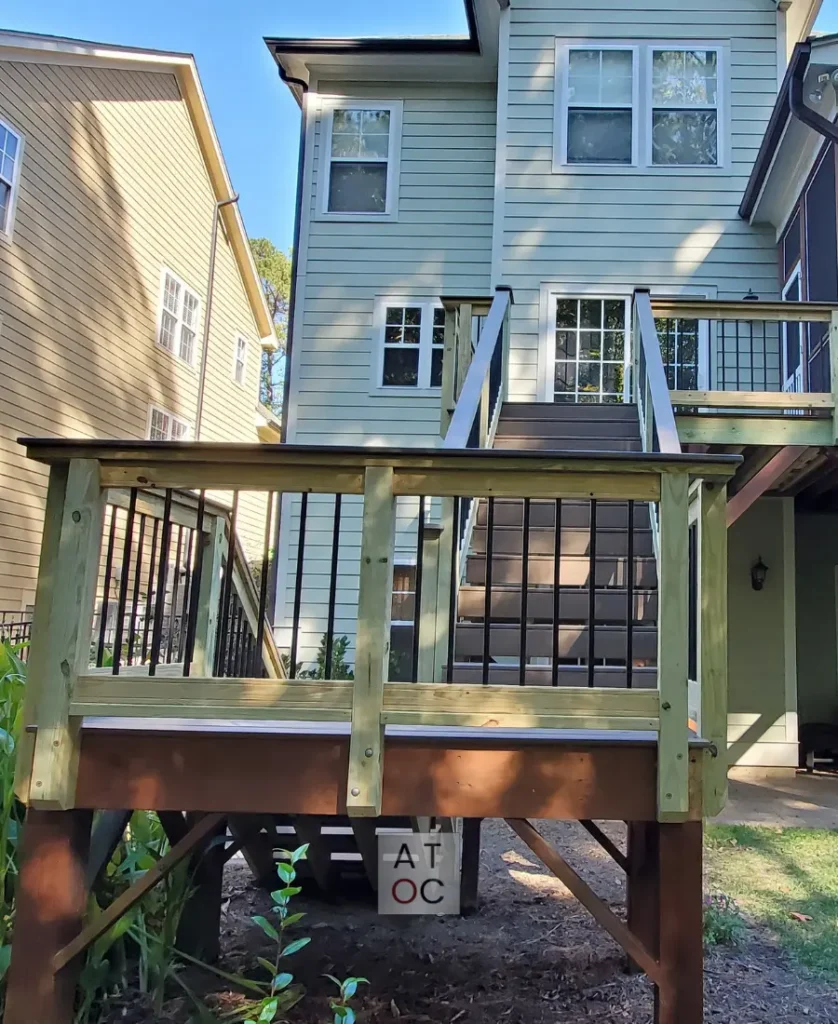 Two-story porch staircase construction in Northwest Raleigh (27613) featuring low-maintenance composite flooring and upgraded modern handrails for enhanced safety and durability.