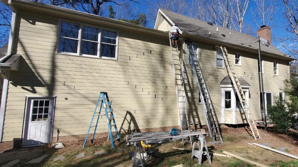 Primed HardiePlank siding on the back of a house in Raleigh, NC.