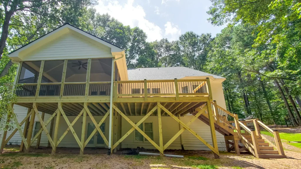 A large 24x16 rear porch and 18x16 deck attached with a long staircase built by A Touch of Color Painting & General Contracting of Raleigh, NC.