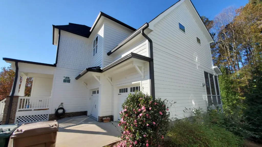 Side view of home gutters on white home installed by A Touch of Color.