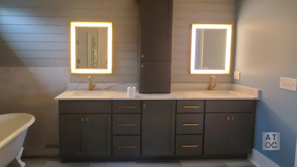 Detailed view of a navy blue bathroom cabinet refinishing project, highlighting the durable satin finish and updated gold hardware in a local residence.
