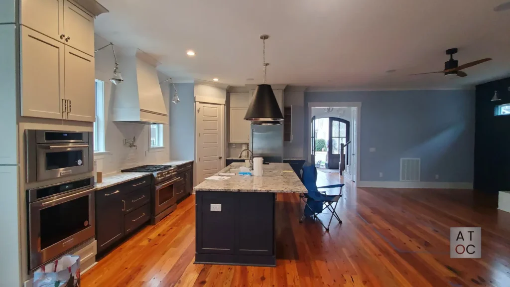 Full-room view of a bright, modern kitchen transformation featuring professionally painted cabinetry and updated color palette in the Triangle area.