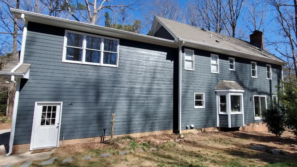 Dark blue painted siding and contrasting white trim after a siding install in Raleigh, NC.