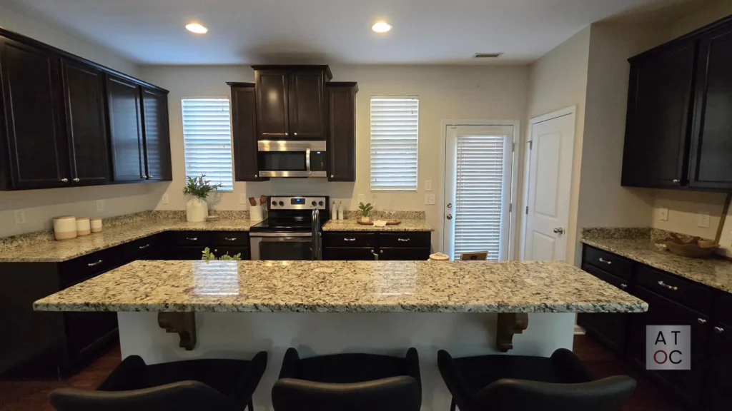 Classic dark wood stained kitchen cabinetry in a Raleigh home, representing a durable traditional finish for homeowners who prefer natural wood grain.