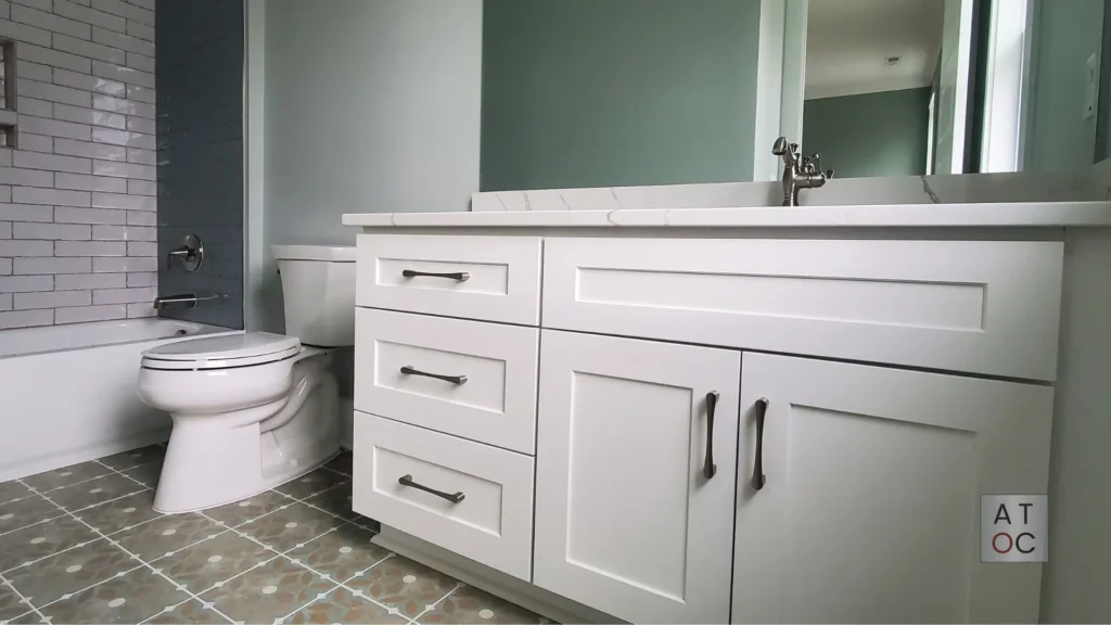 Close-up of a factory-smooth white bathroom vanity refinishing in Raleigh, NC, showcasing the professional spray finish and precision edge work.