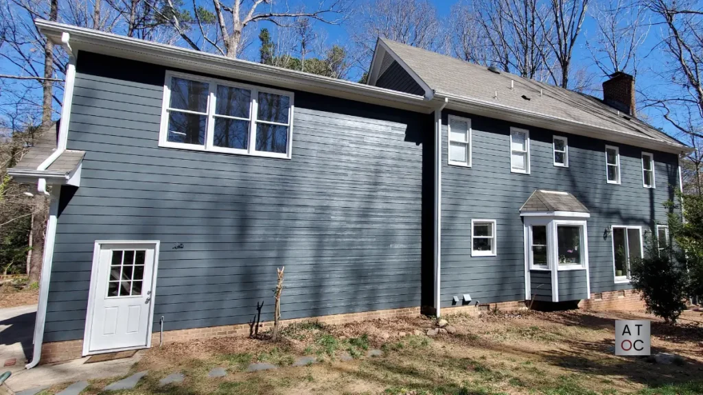 Blue fiber cement siding installation on a Raleigh home near Penny Road.