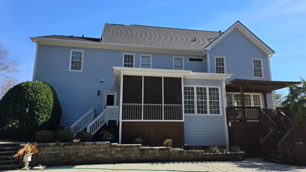 A rear image of a deck and porch completed and stained on a freshly painted home exterior in Wake Forest, NC.