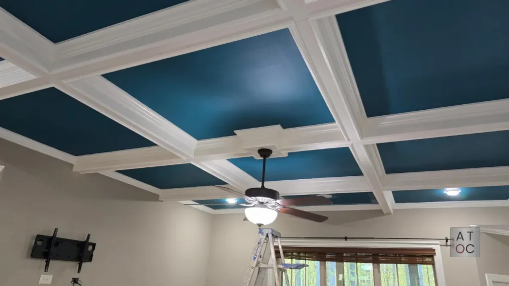 Detailed coffered ceiling painting in a bold bright blue for a custom home in the Green Level area of Cary (27519), showcasing precision edge work and professional spray finishing.