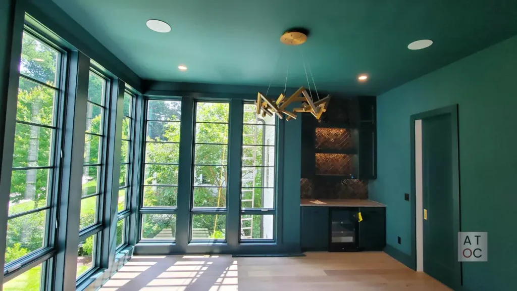 Elegant dining room in Raleigh featuring a bold 2026 jewel-tone finish and professional monochromatic trim work.