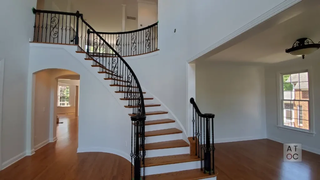 Modern high-contrast interior painting in Cary (27523) near Green Level Road, featuring a clean white palette and custom black handrail refinishing.