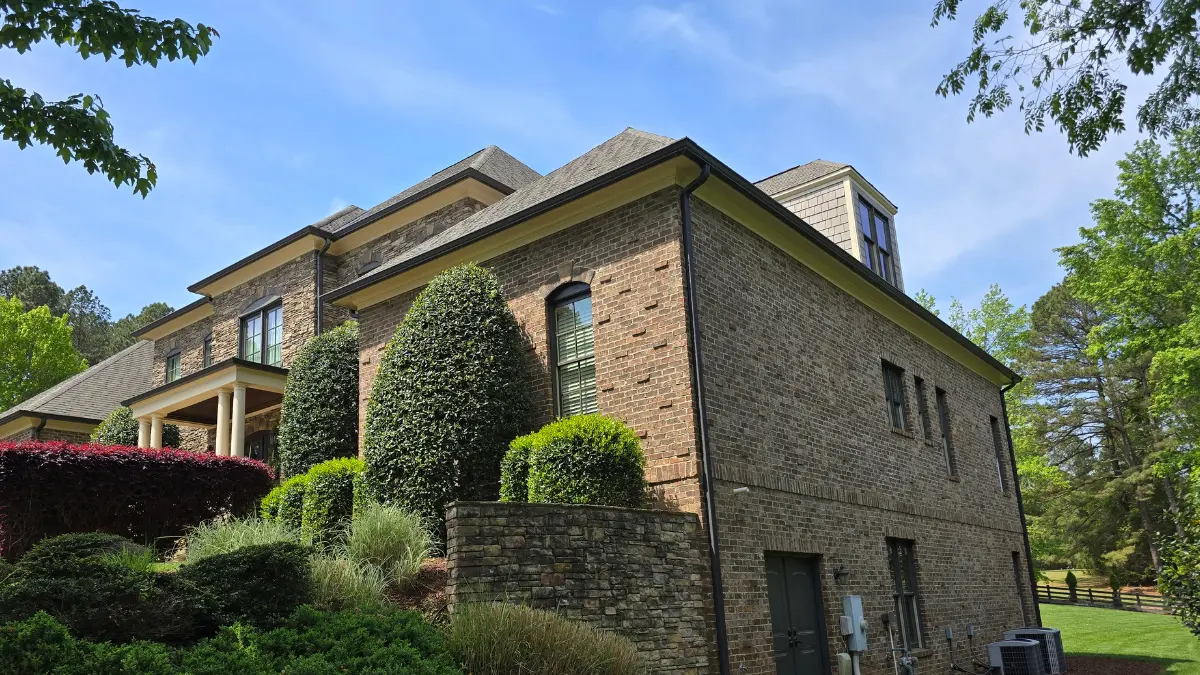 The side view of a home painted in Raleigh, NC on Durant Rd (27614) by A Touch of Color Painting.