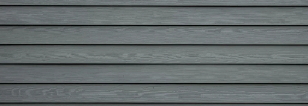Gray background image of painted siding on a home by A Touch of Color Painting & General Contracting in Raleigh, NC.