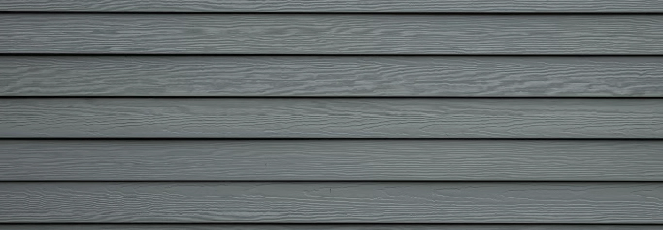 Gray background image of painted siding on a home by A Touch of Color Painting & General Contracting in Raleigh, NC.