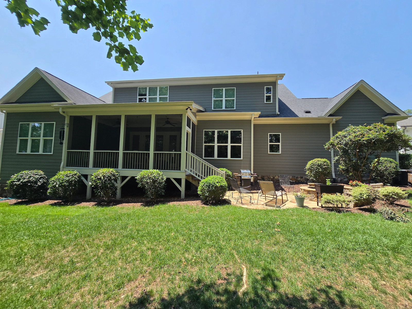A gray house with cream trim painted by A Touch of Color Painting.