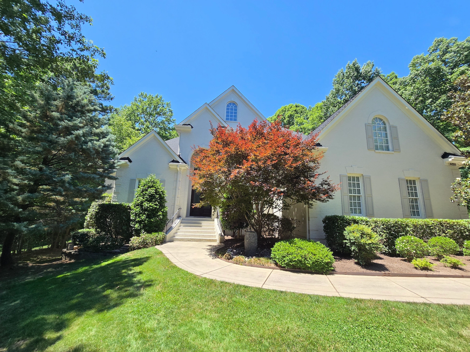 Wake Forest home painted white brick and light colored shutters.