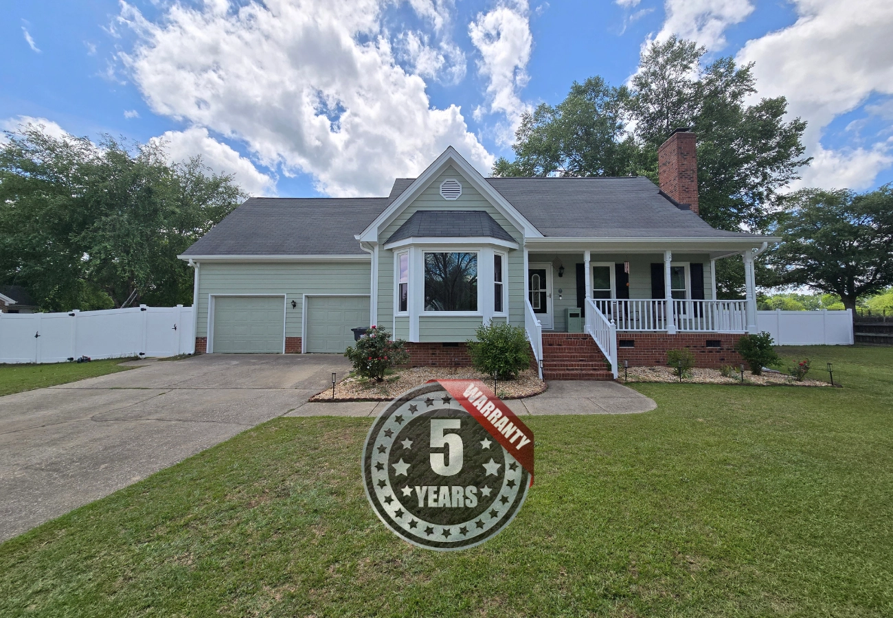 Home exterior renovation including painting, gutters, and siding completed in Raleigh, NC. 
