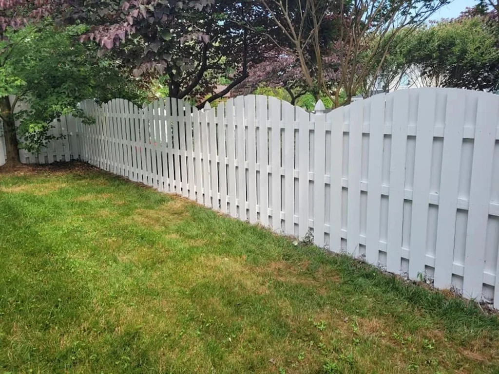 Professional white fence restoration on Arnold Palmer Drive in the Brier Creek community of Raleigh, NC, featuring meticulous surface scraping and high-adhesion exterior painting to protect against blistering peeling and organic growth.